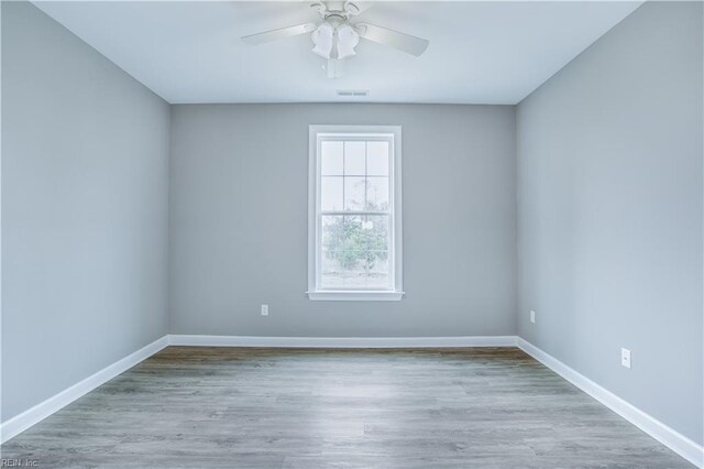 spare room featuring light hardwood / wood-style floors and ceiling fan