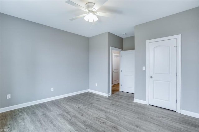 unfurnished bedroom with ceiling fan and light hardwood / wood-style flooring