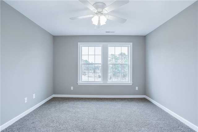 carpeted spare room with ceiling fan