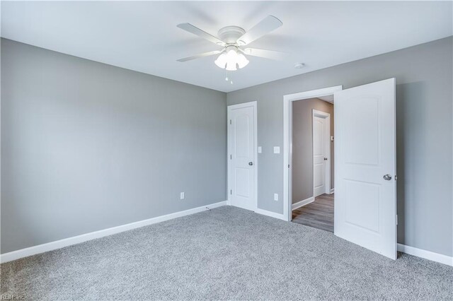 unfurnished bedroom featuring carpet flooring and ceiling fan