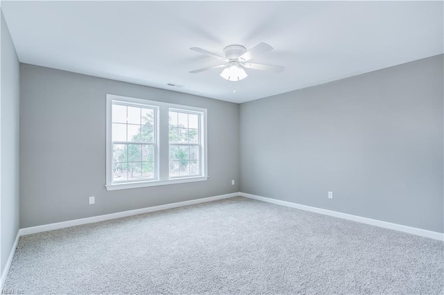 empty room featuring carpet flooring and ceiling fan