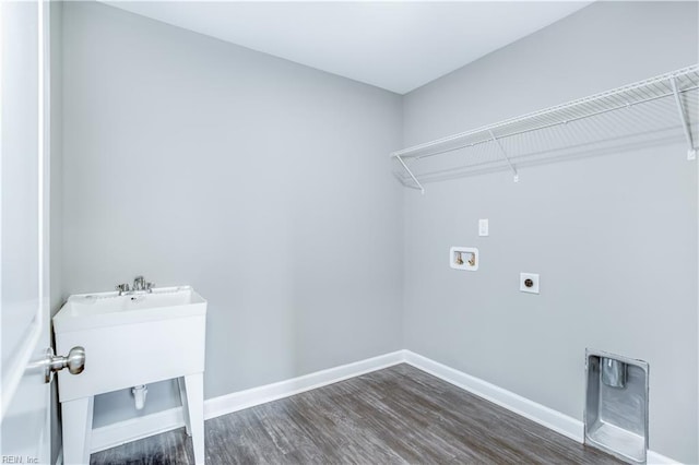 clothes washing area with hookup for an electric dryer, hookup for a washing machine, and dark hardwood / wood-style floors