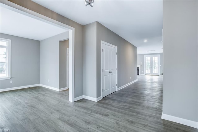 hallway featuring dark hardwood / wood-style flooring and french doors