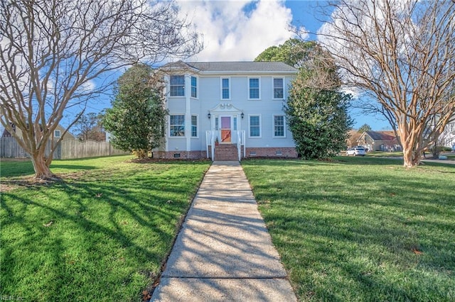 colonial inspired home with a front lawn