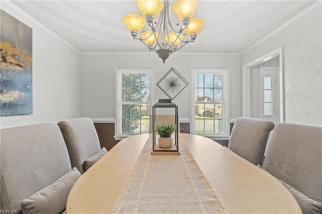 dining area featuring an inviting chandelier, a wealth of natural light, and ornamental molding