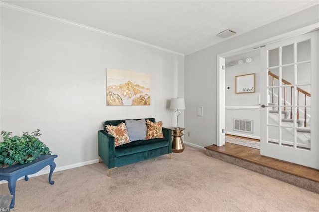 living area featuring carpet floors and ornamental molding