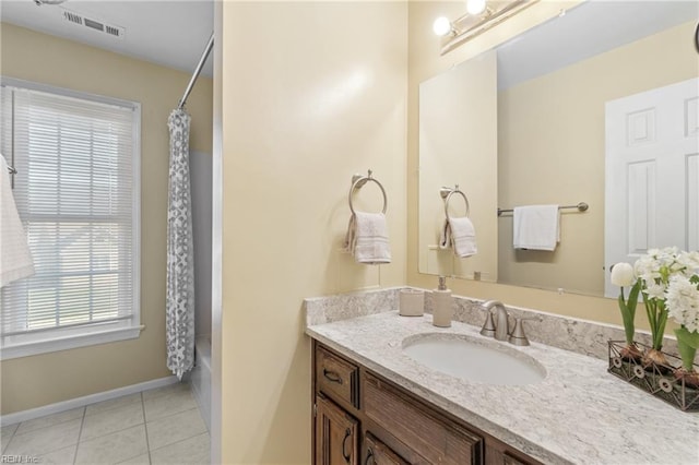 bathroom with tile patterned flooring, shower / bath combo, and vanity