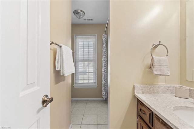 bathroom with tile patterned floors and vanity