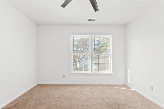 empty room featuring light carpet and ceiling fan