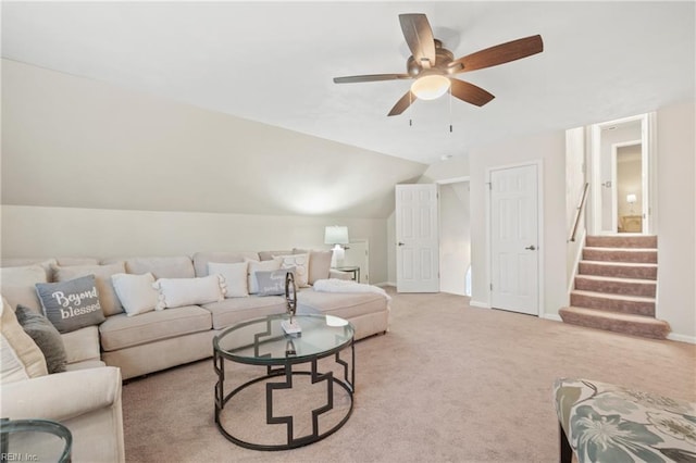 carpeted living room featuring ceiling fan and vaulted ceiling