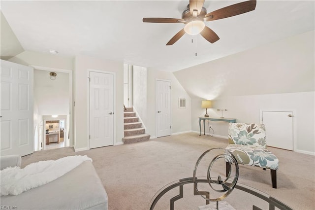 sitting room with ceiling fan, light colored carpet, and lofted ceiling