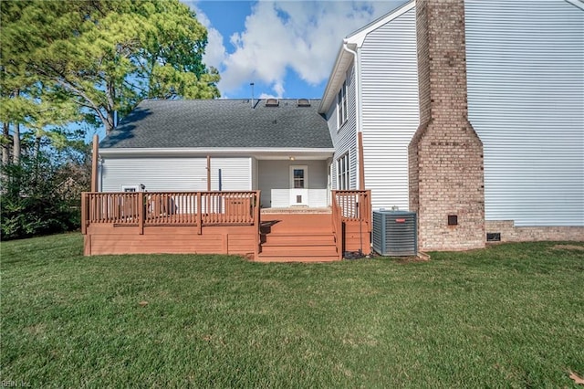 rear view of property featuring central AC unit, a lawn, and a wooden deck