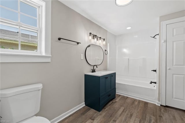 full bathroom featuring wood-type flooring, vanity, toilet, and tub / shower combination