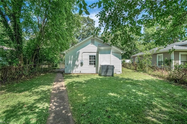 rear view of house featuring a lawn