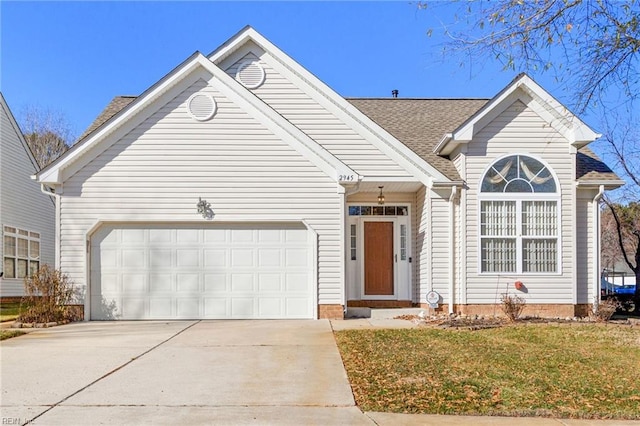 view of front of house with a garage and a front lawn