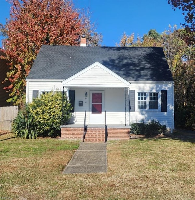 view of front of house with covered porch and a front lawn