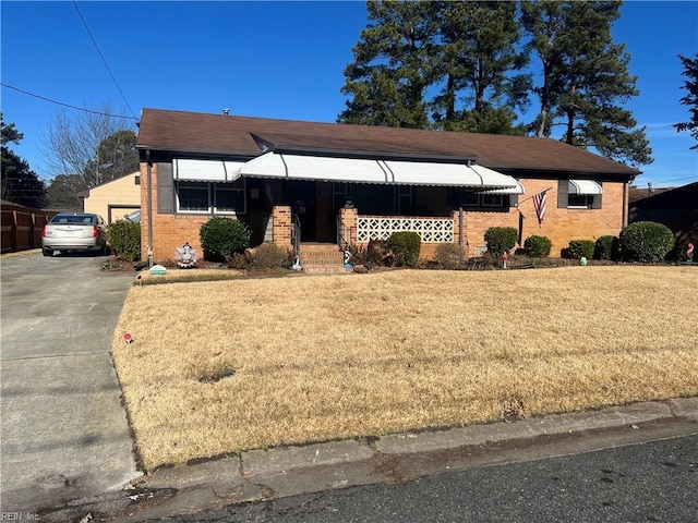 view of front facade featuring a garage, an outbuilding, and a front lawn