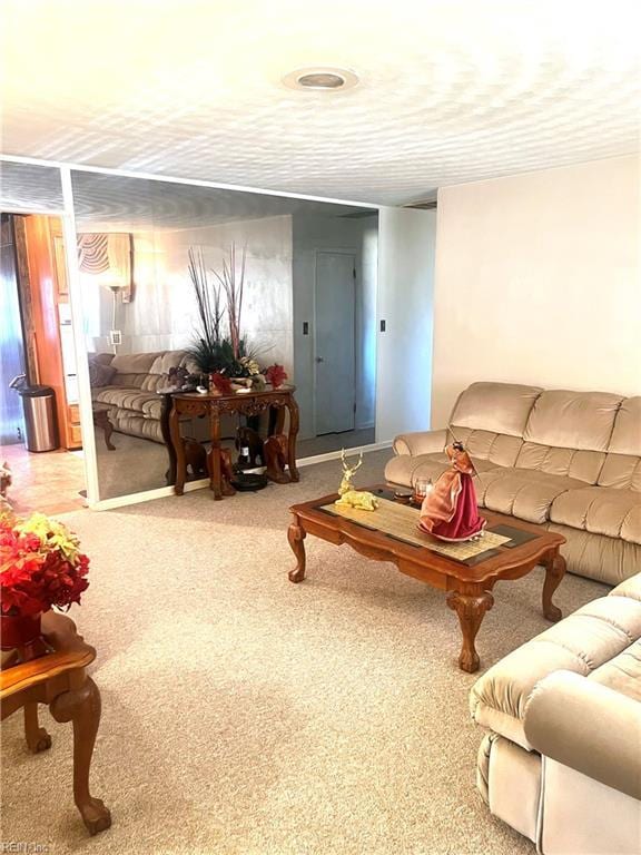 living room with carpet flooring and a textured ceiling