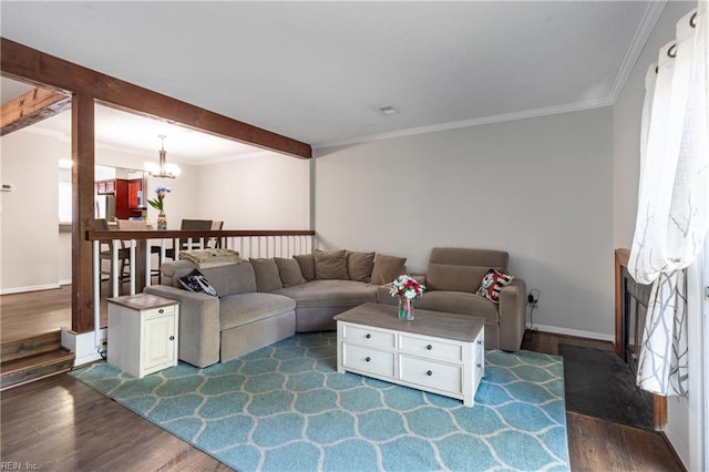 living room featuring a notable chandelier, dark wood-type flooring, and crown molding