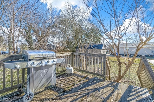 wooden terrace featuring a grill