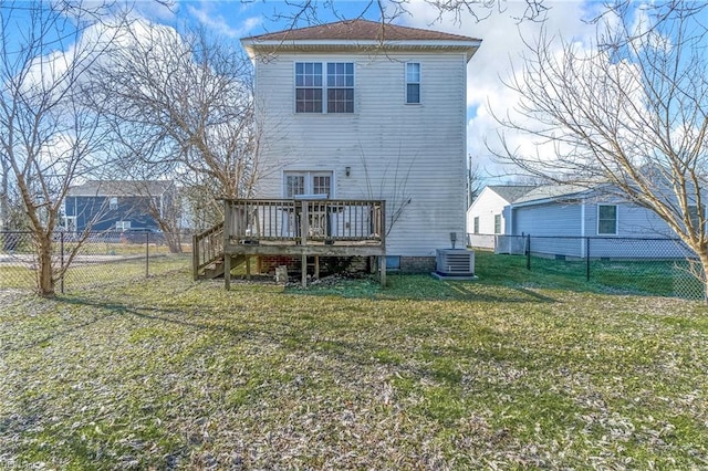 rear view of property with a lawn, cooling unit, and a wooden deck