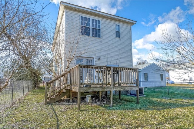 back of property featuring a lawn and a wooden deck