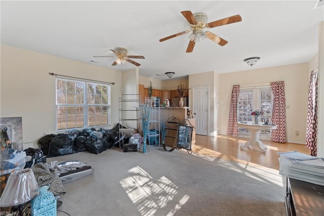 living room featuring light colored carpet and ceiling fan