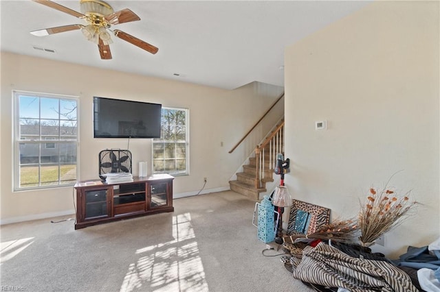 carpeted living room with ceiling fan