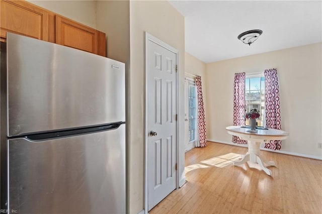 kitchen with stainless steel fridge and light wood-type flooring