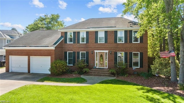 colonial inspired home with a front lawn and a garage