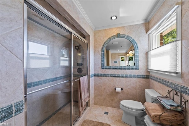 bathroom featuring ornamental molding, a shower with door, tile walls, tile patterned flooring, and toilet