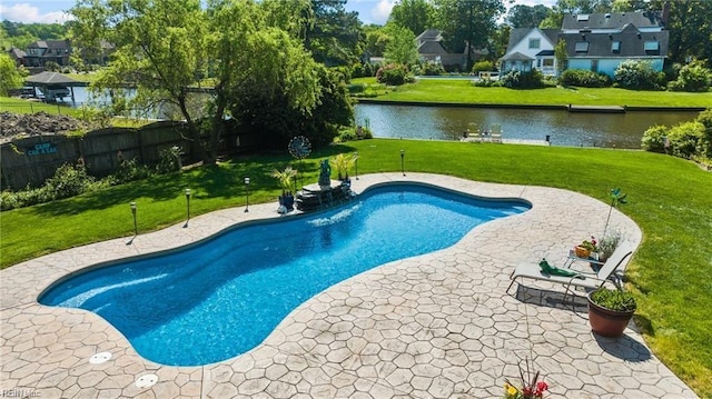 view of swimming pool featuring a lawn, a water view, and a patio