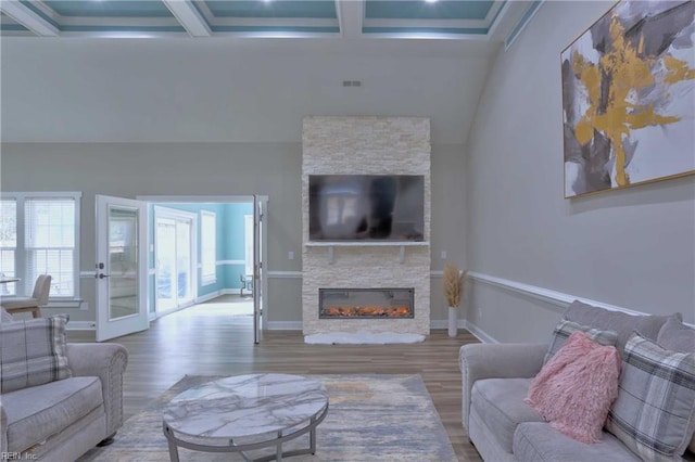 living room with a fireplace, wood-type flooring, beamed ceiling, and coffered ceiling