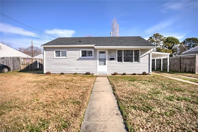 bungalow-style home featuring a front lawn and a carport