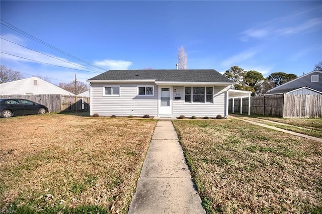 bungalow-style house with a carport and a front yard