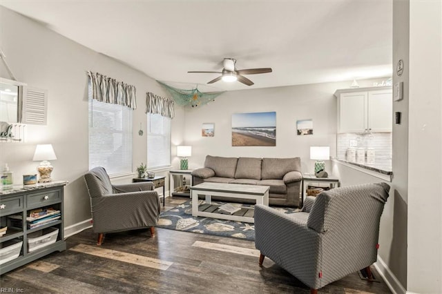 living room featuring ceiling fan and dark hardwood / wood-style flooring