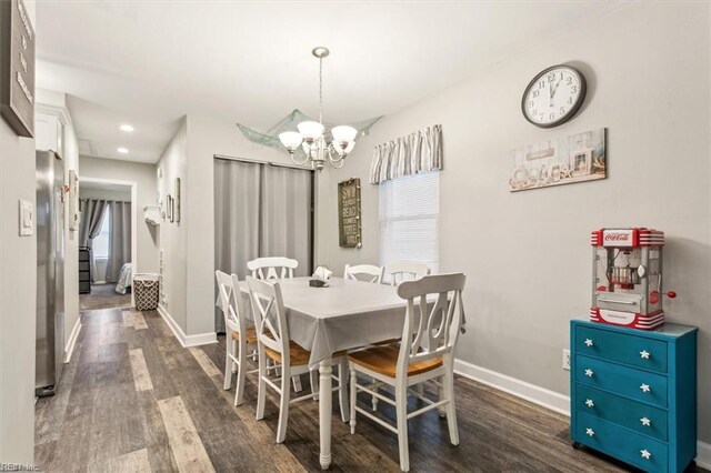 dining area featuring a notable chandelier and dark wood-type flooring