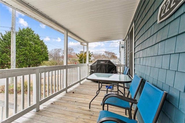 wooden terrace featuring a grill