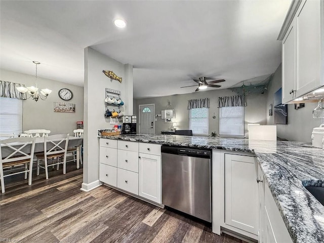 kitchen featuring dark hardwood / wood-style flooring, stainless steel dishwasher, ceiling fan with notable chandelier, dark stone countertops, and white cabinetry