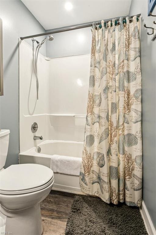 bathroom with hardwood / wood-style floors, shower / bath combo, and toilet