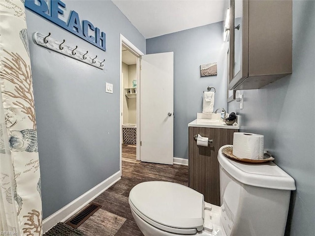 bathroom featuring vanity, toilet, and wood-type flooring