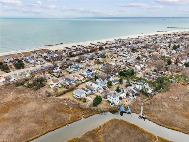 birds eye view of property featuring a water view and a beach view