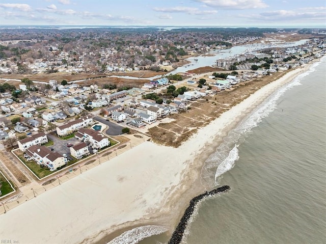 bird's eye view with a water view and a beach view