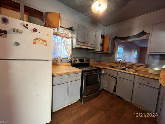 kitchen featuring stainless steel electric stove, white refrigerator, gray cabinetry, and sink