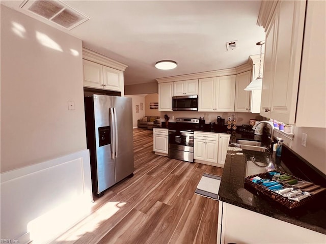 kitchen with sink, stainless steel appliances, and wood-type flooring