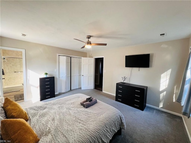 carpeted bedroom featuring a closet, ensuite bath, and ceiling fan