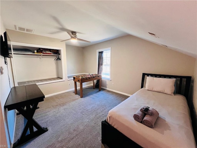 carpeted bedroom with ceiling fan, lofted ceiling, and a closet