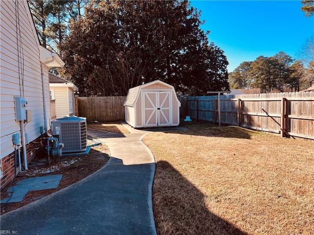 view of yard featuring a storage unit and central AC unit