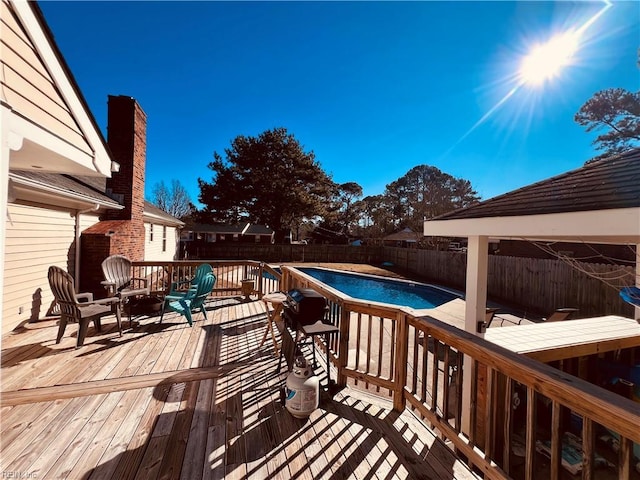 view of swimming pool with a deck