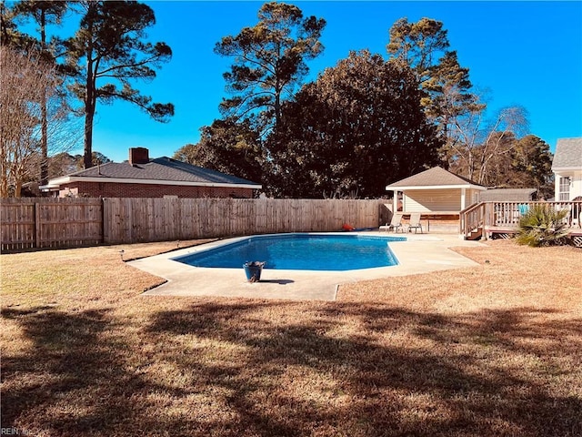 view of pool with a deck and a lawn